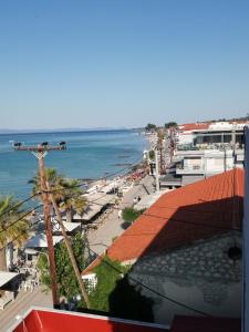 a view of a beach and the ocean from a building at beach apartment in Pefkohori +7 photos