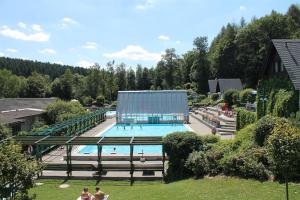 a large swimming pool with a building in the background at Ferienwohnung An der alten Stadtmauer in Annaberg-Buchholz