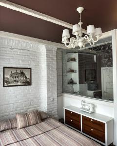 a bedroom with a bed and a sink and a mirror at VIP apartments ! in Lviv