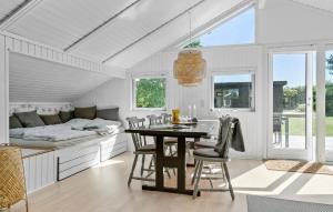 a kitchen with a table and chairs and a bed at Beautiful Home In Odder With Wifi in Odder