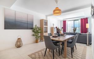 a dining room and living room with a table and chairs at Nice Apartment In Estepona With Wifi in Estepona
