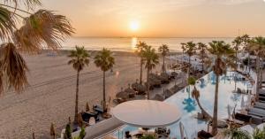 an aerial view of a resort with a pool and the beach at Sweet Suites in Valencia