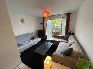 a living room with a couch and a table at Nort sur erdre centre in Nort-sur-Erdre