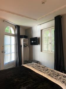 a bedroom with a bed and a window at Art Hotel in Rochecorbon