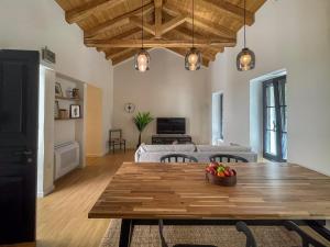a living room with a table and a couch at Bigtrel Athens in Athens