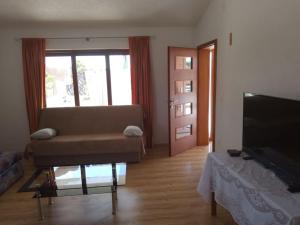 a living room with a couch and a television at Sea and Sun Pakoštane in Pakoštane