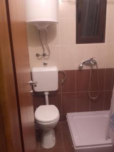 a bathroom with a toilet and a bath tub at Sea and Sun Pakoštane in Pakoštane +36 photos