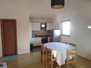 a kitchen and dining room with a table and chairs at Sea and Sun Pakoštane in Pakoštane