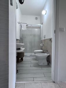 ein Badezimmer mit zwei Waschbecken, Toilette und Dusche in der Unterkunft Podere 406 in Pescia Romana