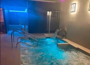 a pool of water with a water slide in a bathroom at Hotel Spa Martín el Humano in Segorbe
