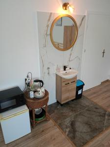 a bathroom with a sink and a mirror at Baza Noclegowa ARKADIA in Świnoujście
