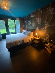 a bedroom with a bed and a wall with deer skulls at The Lodge in Best