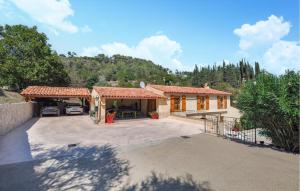 a house with a car garage and a driveway at Beautiful Home In La Colle-Sur-Loup in La Colle-sur-Loup