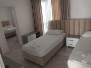 Postel nebo postele na pokoji v ubytování Hotel Ani