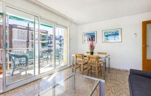 a living room with a table and chairs at 3 Bedroom Nice Apartment In Santa Pola in Santa Pola