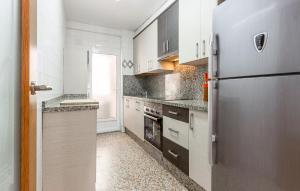 a kitchen with a stainless steel refrigerator and counters at 3 Bedroom Nice Apartment In Santa Pola in Santa Pola