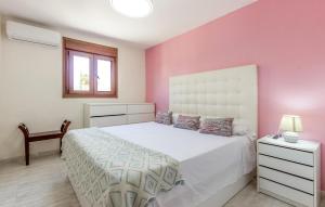 a bedroom with a white bed and a pink wall at Beautiful Home In Aguilas With Wifi in Águilas