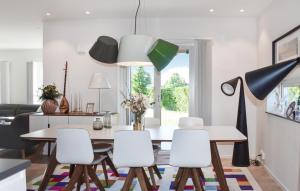 a dining room with a table and white chairs at Awesome Home In Malmö With Wifi in Malmö