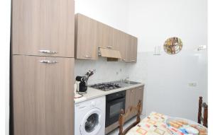 a kitchen with a stove and a washing machine at Beautiful Apartment In Ragusa With Wifi in Ragusa