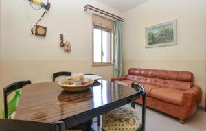 a living room with a table and a leather couch at Villa Tony in Licodia Eubea