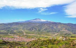 a view of a mountain with a town and houses at Cozy Home In Mascali With Wifi in Mascali