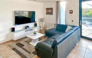 a living room with a couch and a tv at 3 Bedroom Gorgeous Home In Lemmer in Lemmer