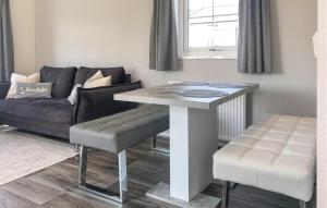 a living room with a table and a couch at Beautiful Stacaravan In Julianadorp in Julianadorp