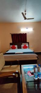 a hotel room with a bed and a table with water bottles at CHETAN INN HOTEL in Bhubaneshwar