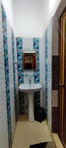a bathroom with a sink and a mirror at CHETAN INN HOTEL in Bhubaneshwar