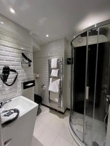 a bathroom with a shower and a sink at Art Hotel in Rochecorbon