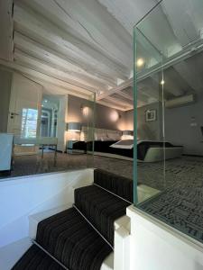a room with a couch and a bed and a mirror at Art Hotel in Rochecorbon