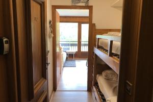 a room with a bedroom with bunk beds and a hallway at Family studio near the slopes of Praz-sur-Arly in Praz-sur-Arly