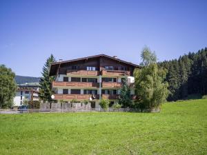 duży dom na wzgórzu z zielonym polem w obiekcie Appartement Lana - by NV-Appartements w mieście Kirchberg in Tirol