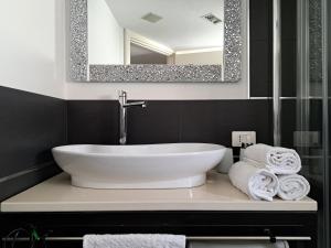 a bathroom with a sink and a mirror and towels at Casa Margherita in Noci +51 photos