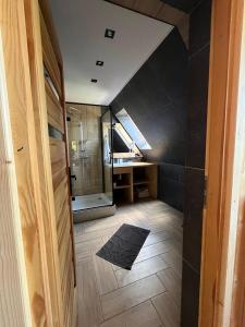 a bathroom with a sink and a shower in a room at Bioło Izba Apartament w Zębie in Ząb +11 photos