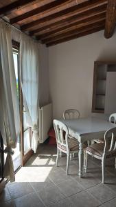 a dining room with a table and chairs and a window at Mary's House in Guardistallo +6 photos