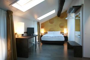 a bedroom with a bed and a television in it at Hotel Internazionale Bellinzona in Bellinzona +37 photos