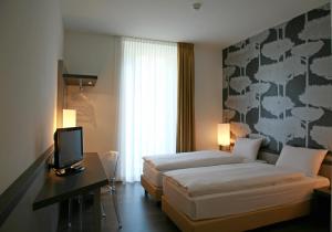 Ліжко або ліжка в номері Hotel Internazionale Bellinzona