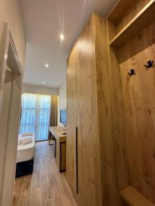 a room with a bed and a wooden wall at Hotel Harper Durres in Durrës +19 photos
