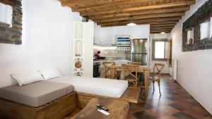 a bedroom with a bed and a table and a kitchen at Patriko in Skiros