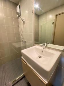 a white bathroom with a sink and a mirror at Ideo O2 BTS Bangna in Bangkok +25 photos