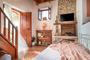 a bedroom with a bed and a tv on a wall at Pirgali Stone house in Ampavris +35 photos