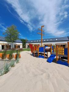 a playground with a slide in the sand at Morze Las in Ustka