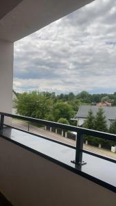 a view of a balcony with a view of trees at APARTAMENT MARTA in Biłgoraj