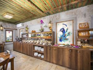 a restaurant with a counter filled with lots of food at Rapsodi Cappadocia in Göreme +27 photos