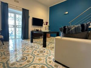 a living room with a couch and a table at Seaview Home Bacoli in Bacoli