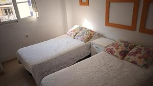 Ένα ή περισσότερα κρεβάτια σε δωμάτιο στο APTO GAVINA PLAZA TRIANGULAR , A Pié De PLAYA LEVANTE