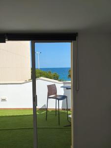 a chair sitting outside of a sliding glass door at Hotel Serenity Platja d'Aro by Pandora Hoteles in Platja d'Aro
