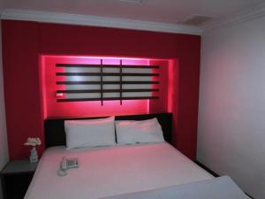 Ein Bett oder Betten in einem Zimmer der Unterkunft Hotel China Town 2