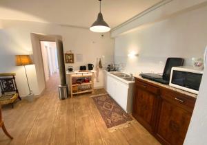 a kitchen with a sink and a microwave at Chez Nellane - Poitiers - HyperCentre in Poitiers +8 photos